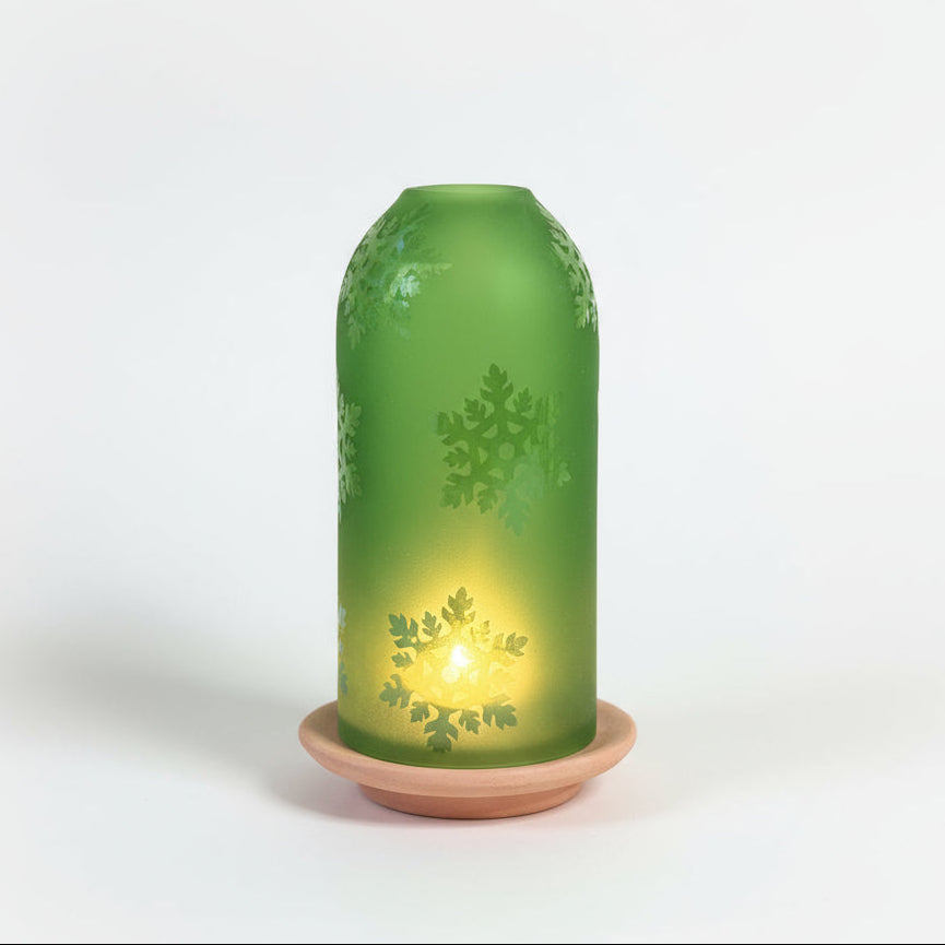 Green upcycled glass lantern with snow flakpatterns ethically handcrafted by women artisans, fair trade
