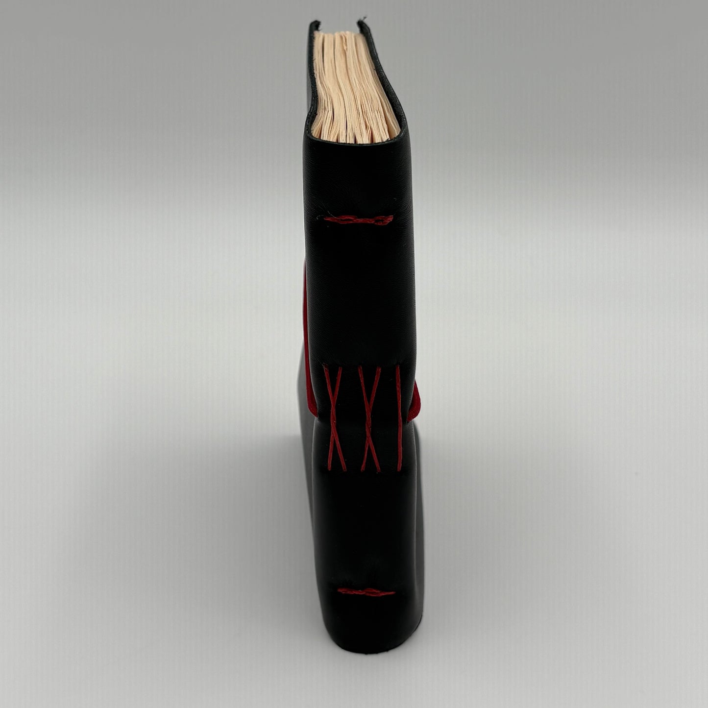 Handcrafted black leather journal with red string Coptic stitching, cruelty-free, fair trade, ethically handmade