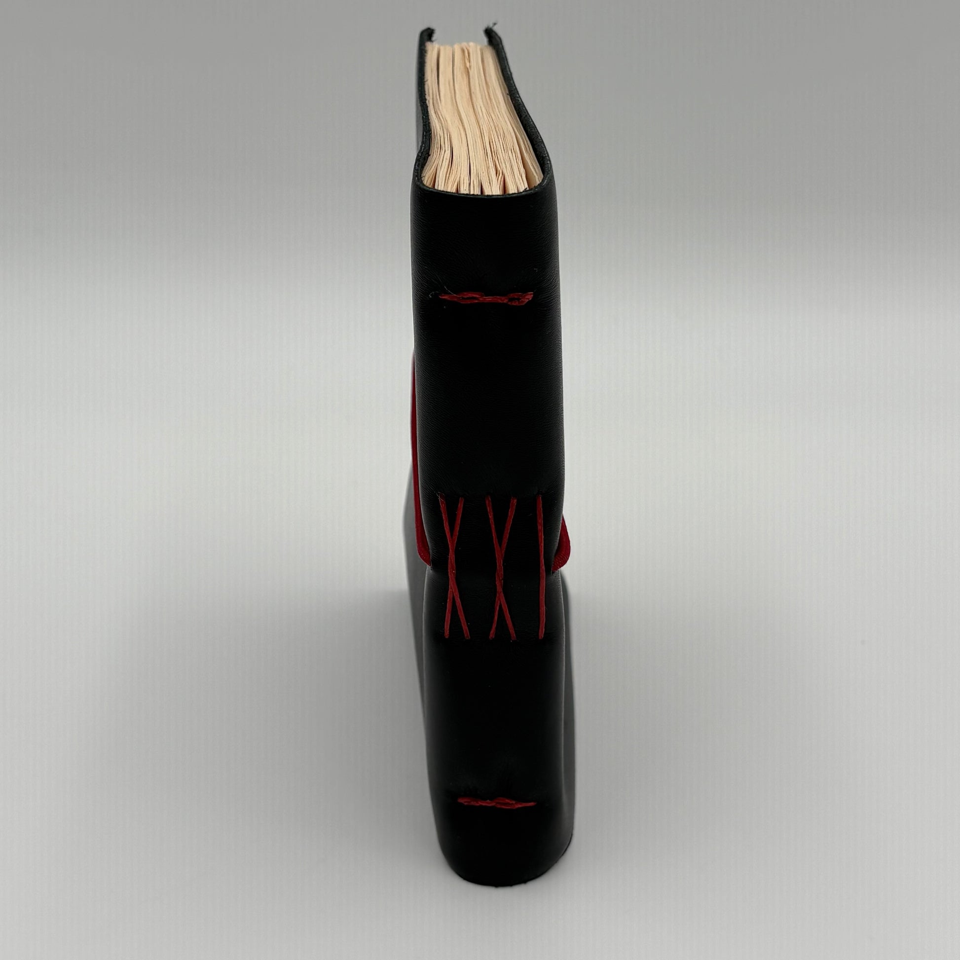 Handcrafted black leather journal with red string Coptic stitching, cruelty-free, fair trade, ethically handmade