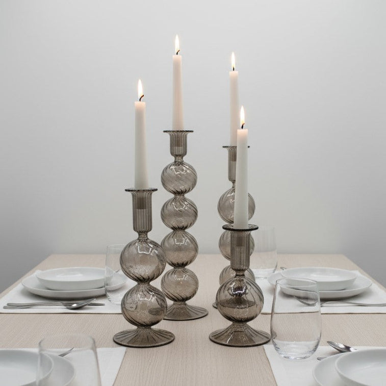 Decorative handblown glass long stem candle holders with baubles in smoky, centerpiece
