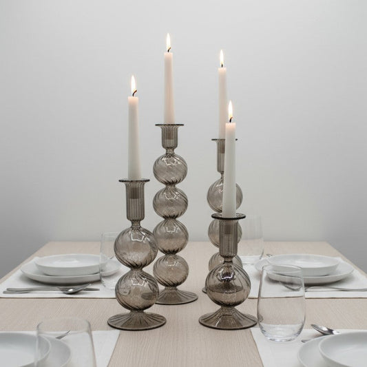 Decorative handblown glass long stem candle holders with baubles in smoky, centerpiece