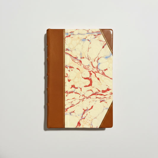 Handbound notebook journal with marbled cover and dark blue leather spine and corners, fair trade