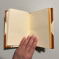 Handbound notebook journal with marbled cover and dark blue leather spine and corners, fair trade