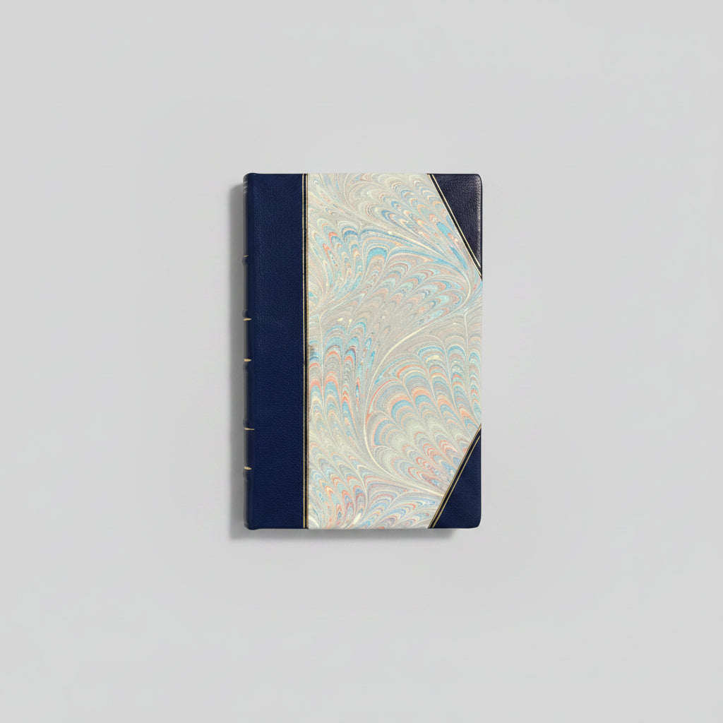 Handbound notebook journal with marbled cover and dark blue leather spine and corners, fair trade