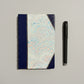 Handbound notebook journal with marbled cover and dark blue leather spine and corners, fair trade