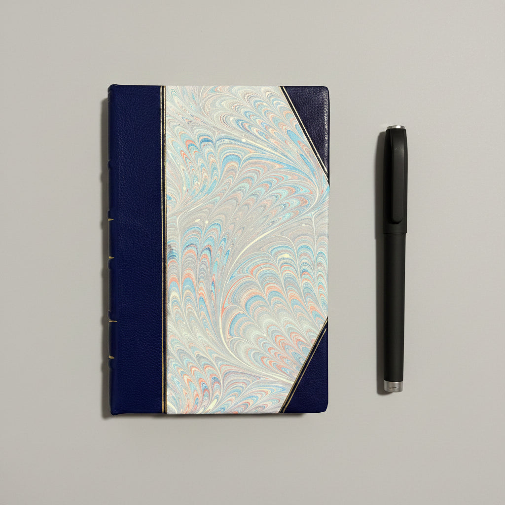 Handbound notebook journal with marbled cover and dark blue leather spine and corners, fair trade