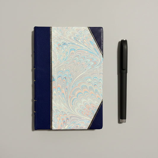 Handbound notebook journal with marbled cover and dark blue leather spine and corners, fair trade