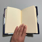 Handbound notebook journal with marbled cover and dark blue leather spine and corners, fair trade