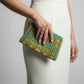 Colorful fair trade hand-beaded clutch with geometric chevron design, ethical fashion