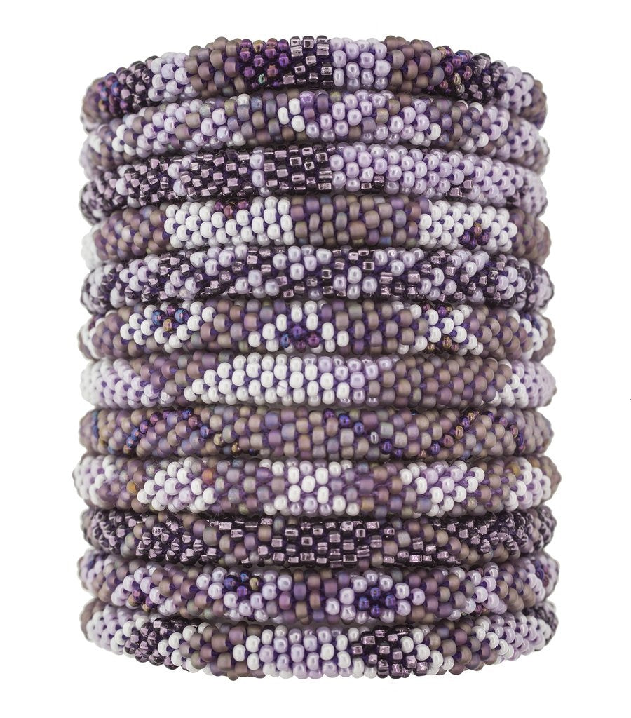 Hand-beaded bracelets in various shades of mauve, ethically handmade by women artisans of glass beads, fair trade
