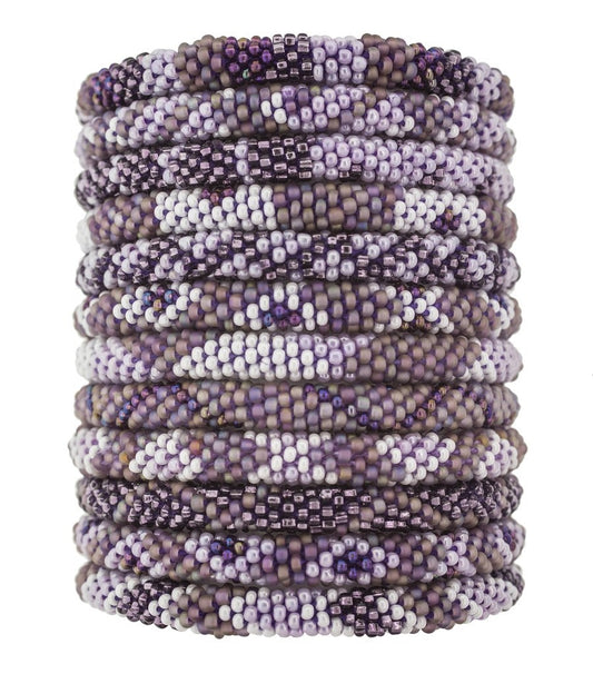 Hand-beaded bracelets in various shades of mauve, ethically handmade by women artisans of glass beads, fair trade