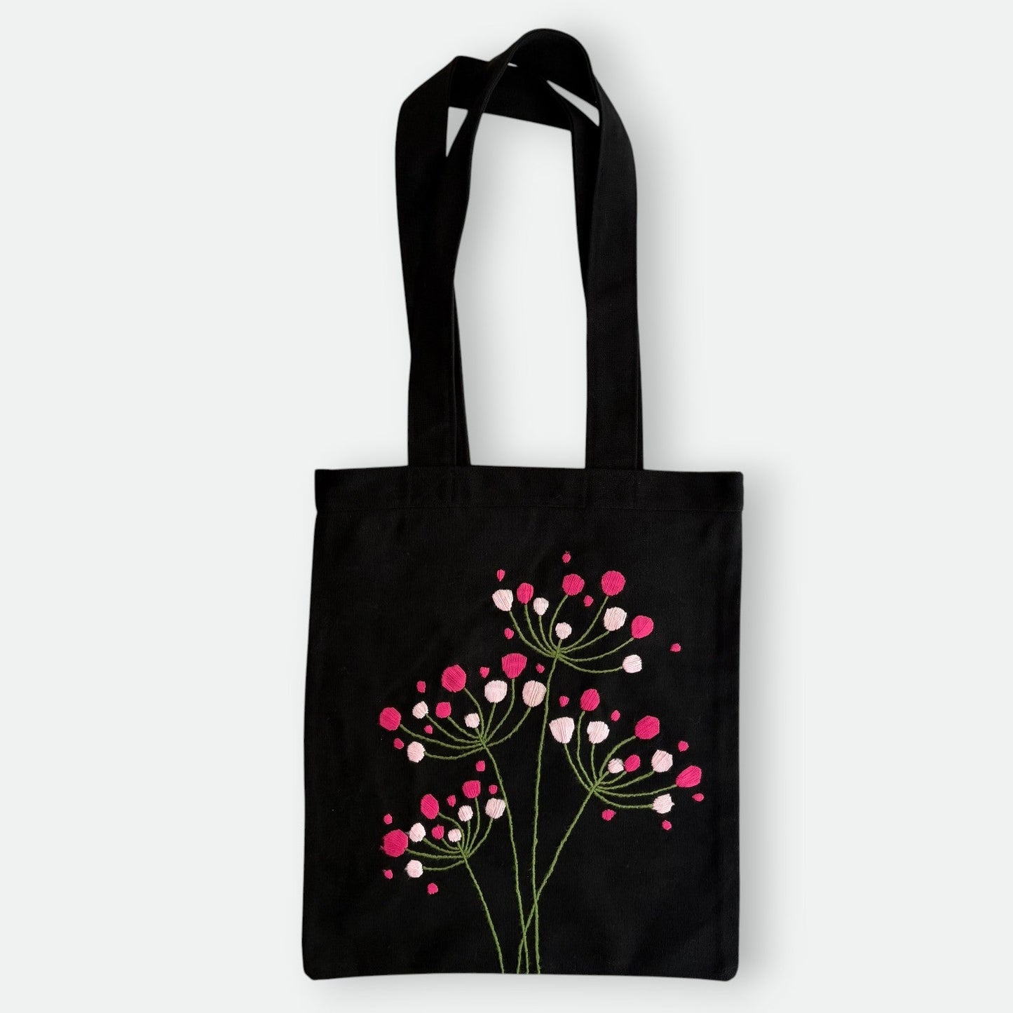 Handmade black tote bag with hand-embroidered fuchsia and pink hydrangea, fair trade