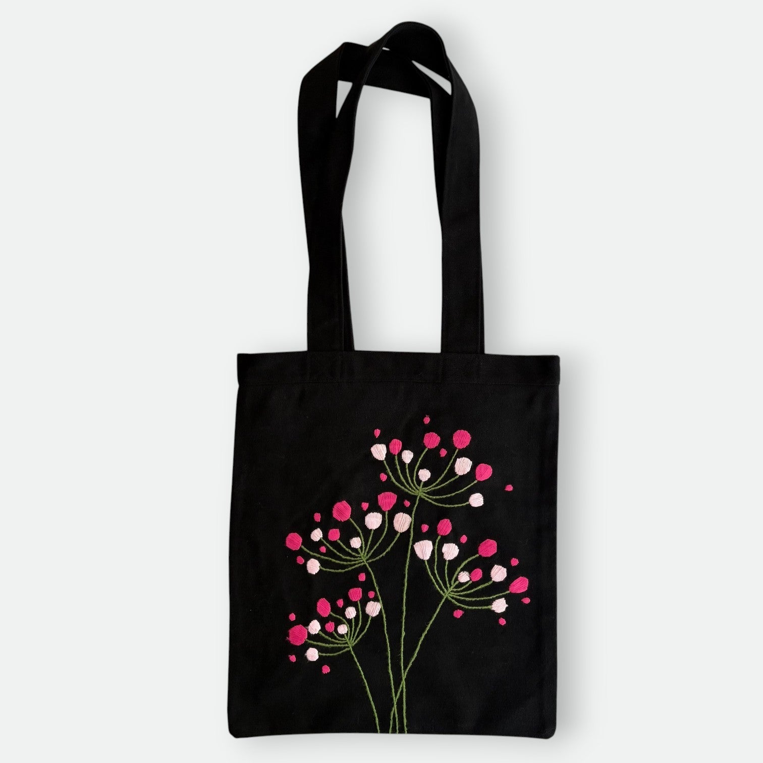 Handmade black tote bag with hand-embroidered fuchsia and pink hydrangea, fair trade