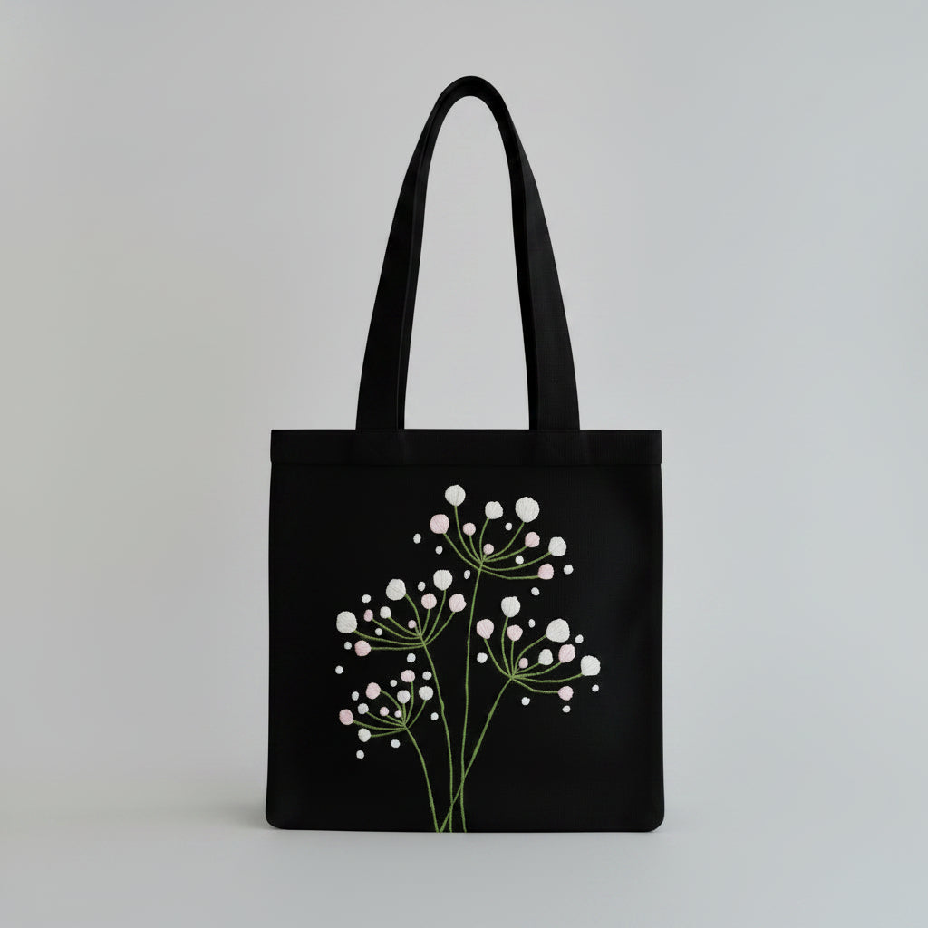 Handmade black tote bag with hand-embroidered white hydrangea, fair trade