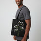 Handmade black tote bag with hand-embroidered white and pink hydrangea, fair trade