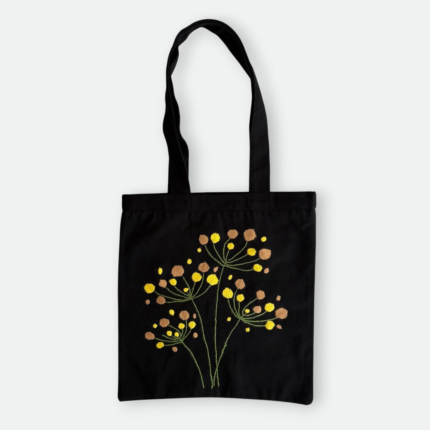 Handmade black tote bag with hand-embroidered yellow and orange hydrangea, fair trade