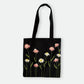 Handmade black tote bag with hand-embroidered pink and white marguerite, fair trade