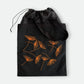 Black canvas tote bag with hand-embroidered orange papyrus design and drawstring lining, fair trade handmade