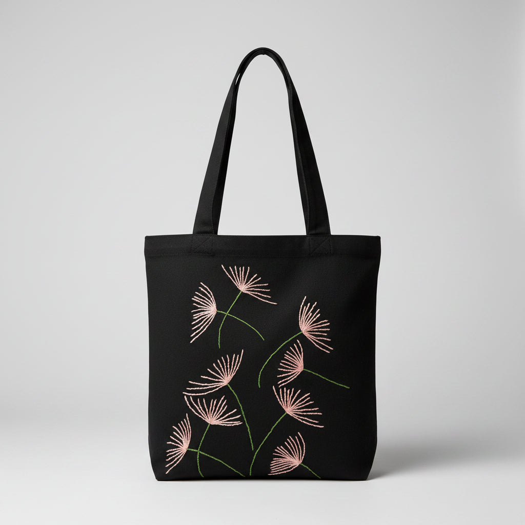 Black canvas tote bag with hand-embroidered pink papyrus design, fair trade handmade