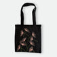 Black canvas tote bag with hand-embroidered pink papyrus design, fair trade handmade