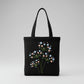 Handmade black tote bag with hand-embroidered light blue and pink hydrangea, fair trade