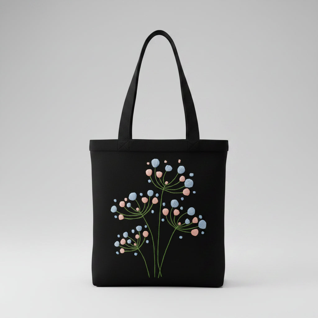 Handmade black tote bag with hand-embroidered light blue and pink hydrangea, fair trade