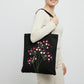 Handmade black tote bag with hand-embroidered fuchsia and pink hydrangea, fair trade
