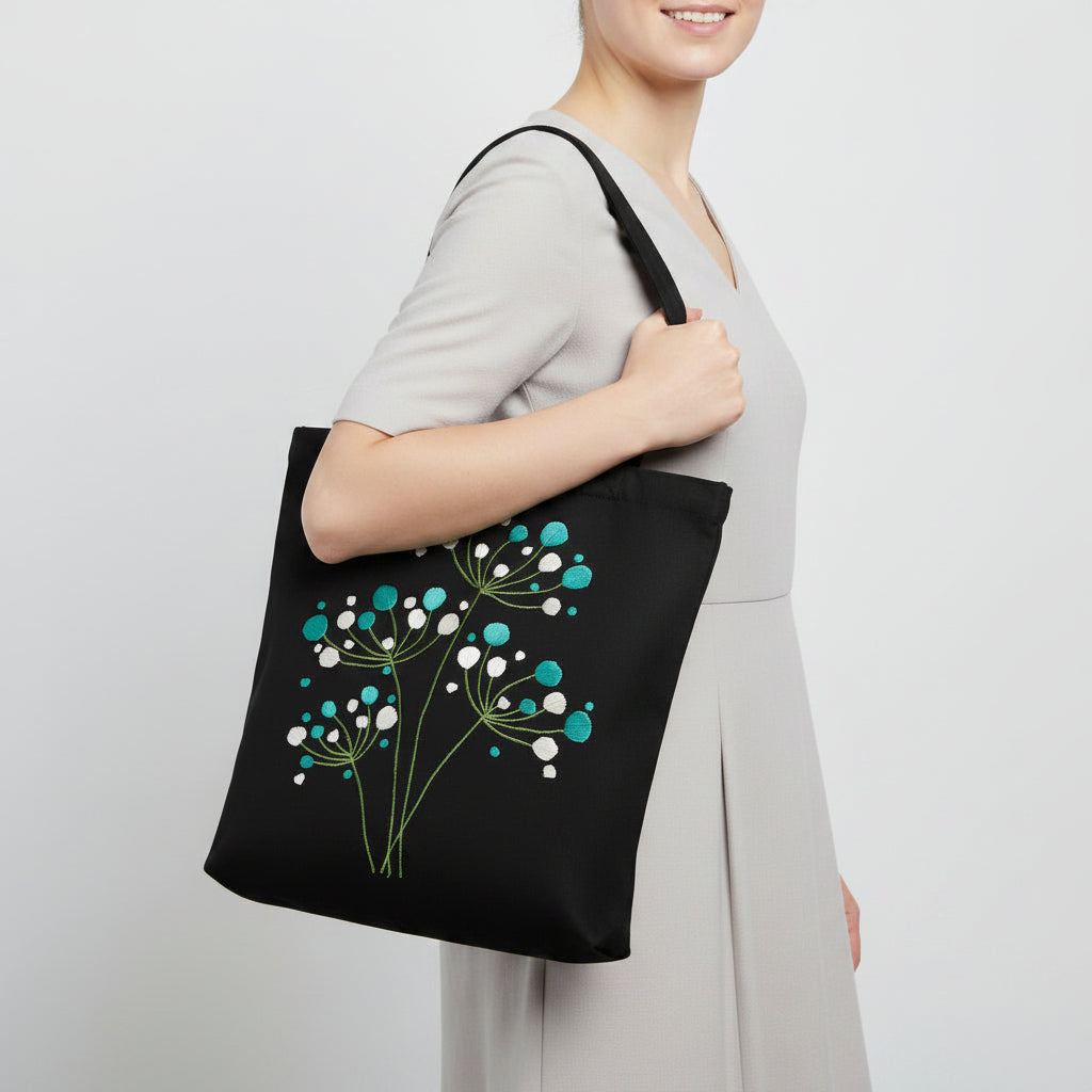 Handmade black tote bag with hand-embroidered white and turquoise hydrangea, fair trade