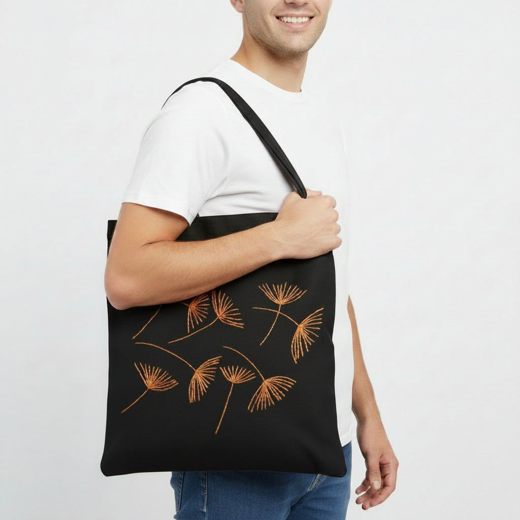 Black canvas tote bag with hand-embroidered orange papyrus design, fair trade handmade