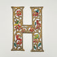 Decorative wall art letter 'H' with floral and bird designs, ethically and sustainably handcrafted, fair trade handmade