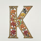 Decorative wall art letter 'K' with floral and bird designs, ethically and sustainably handcrafted, fair trade handmade