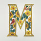 Decorative wall art letter 'M' with floral and bird designs, ethically and sustainably handcrafted, fair trade handmade