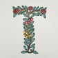 Decorative wall art letter 'T' with floral and bird designs, ethically and sustainably handcrafted, fair trade handmade