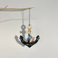 Fair trade handcrafted upcycled metal anchor ornament with a sailboat and fish design, artisan-made, sustainable decor