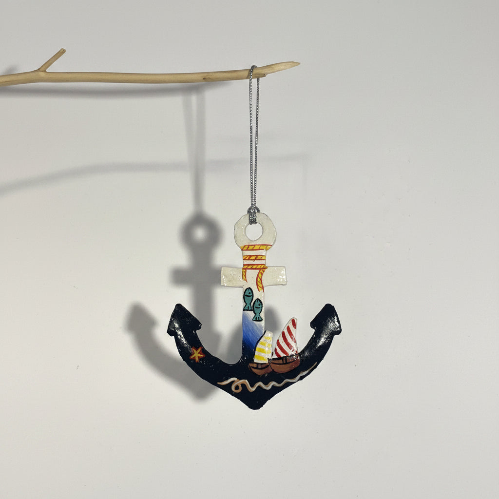 Fair trade handcrafted upcycled metal anchor ornament with a sailboat and fish design, artisan-made, sustainable decor