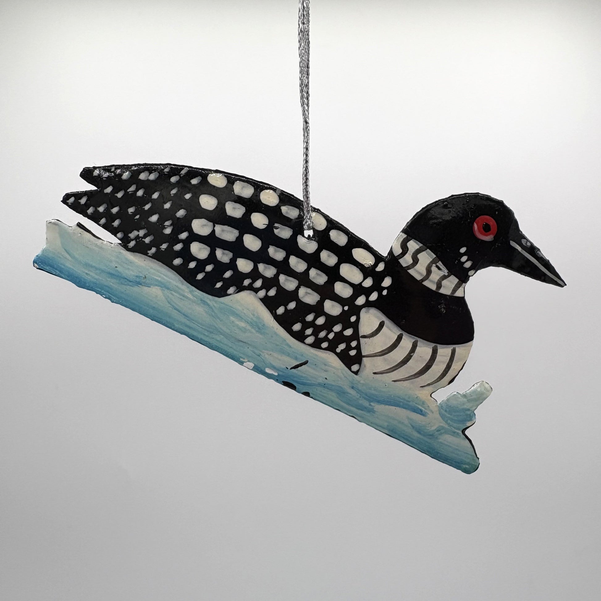 Fair trade handcrafted upcycled metal ornament of a swimming loon bird, ethically handmade